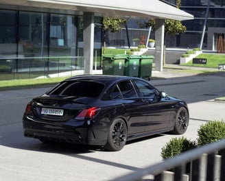 a black car parked on a street corner