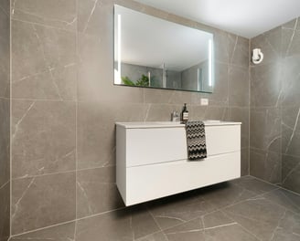 a bathroom with a white sink and a mirror