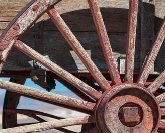 the red spokes of a wooden wagon wheel at harmony borax works in death valley