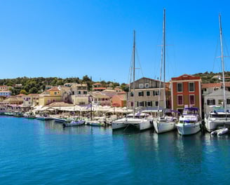 a harbor with boats and buildings in the background