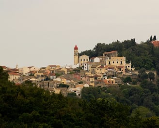 a hill with a church and a clock tower