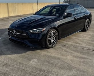 Black Mercedes C300 sedan side view with sporty alloy wheels