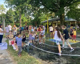 Children in a water balloon fight at Crescent Hills Park