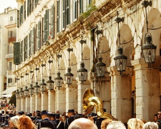 a group of people in uniform marching through a city