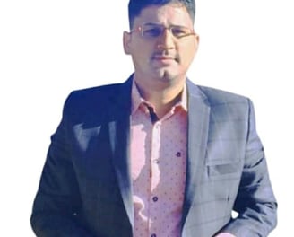 a man homeopathic doctor in a suit and glasses standing in front of a white background