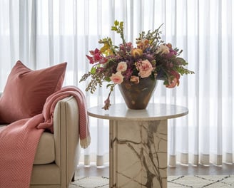 a vase with flowers in a living room