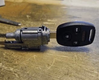 New car key in ignition, representing ignition repair and replacement service