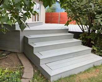 A composite stair case that has skirting around it.