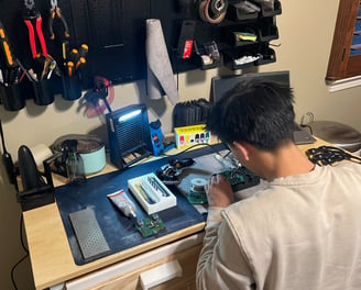 Joshua Lu working on repair a gaming controller for his business venture online.