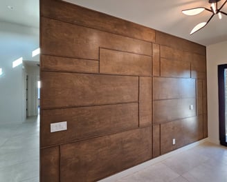 Modern accent wall with medium-tone wood trim, adding warmth and texture to a contemporary interior 