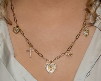 a woman wearing a necklace with a cross on it