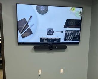 Image of a display with a Logitech Rally Bar