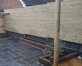 log store, bench, privacy screens sleeper beds and limestone paving