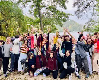 a group of people standing around a lake