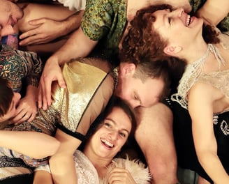 a group of people laying on the floor in a cuddle puddle