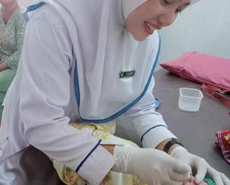 a nurse in a hospital gown is giving a patient a bandage