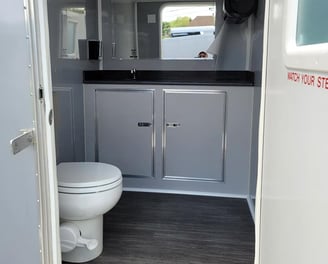 inside a women's' bathroom in a portable luxury restroom trailer at a wedding