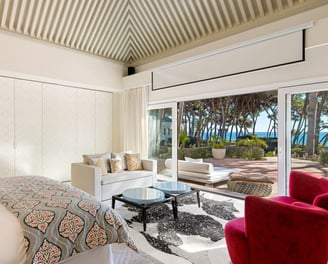 Master suite in the guest house of Villa El Rincon, Marbella, featuring stunning garden and sea views.