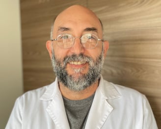 a man in a lab coat and glasses