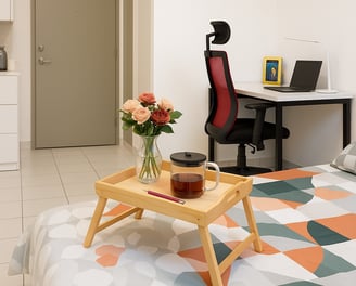 a bed with a tray with a tray with a tray of flowers