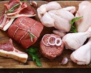 a cutting board with meat and vegetables on it