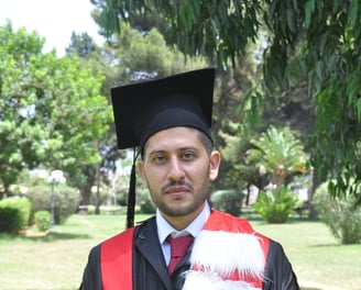 a man in a graduation gown and a cat in a graduation cap