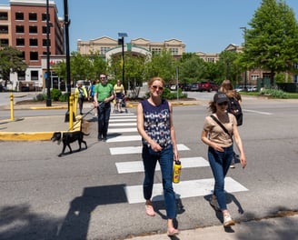 People walking across a crosswalk toward the camera