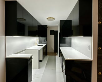 a kitchen with a long counter top and a sink