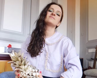 a woman sitting on a chair holding a pineapple chemise vintage couture