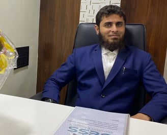 Director of CESS Consultants Sitting at office Desk