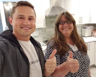 Happy customer posing with Alex, Vision Flooring. On the background brand new kitchen