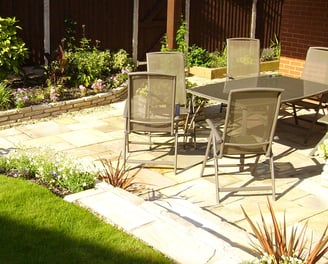 patio design enclosed by raised beds and lawn