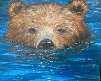 Brown bear swimming in ocean