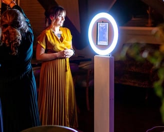 Photo Booth Rental attendant standing in front of a photo booth
