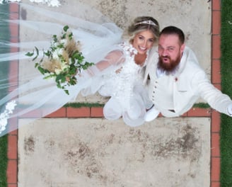 a bride and groom standing on a path