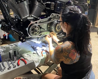 woman working on motorcycle