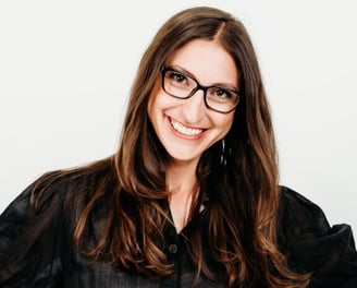 a woman in glasses and a black shirt