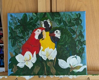 Finished canvas painting of 3 macaws in a magnolia tree.