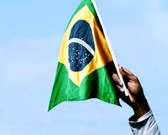 a man holding a flag in front of a building