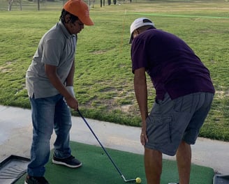 Enhancing Forward Action Inc. image young golfer being taught golf