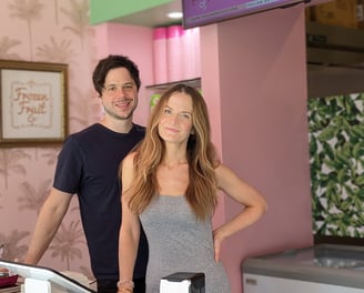 a man and woman standing in front of a counter