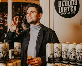 Man at a Business Launch with His Products