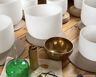 a selection of crystal singing bowls and sound instruments