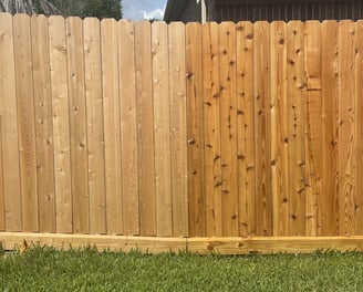 Side by side before and after oil based clear sealant application on a new wooden fence.