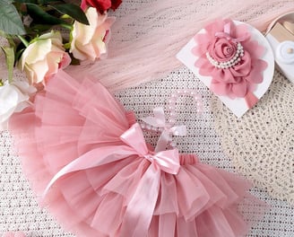 a baby girl's pink tutu skirt with a pink flower headband
