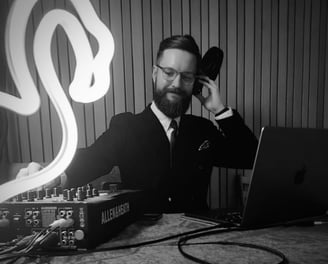 a man in a suit and tie. DJ.