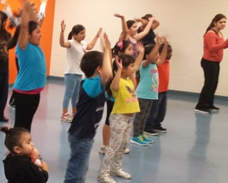 Enhancing Forward Action image of a group of children excising.