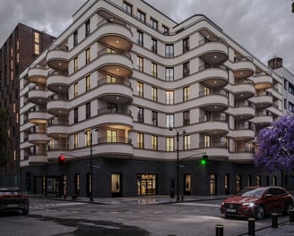 a building with a lot of windows and a car parked in front of it