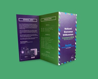 Folded conference programme for Connect 2018 featuring a dark green and navy design.