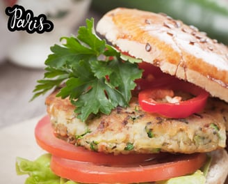 a vegan burger with tomatoes and cheese